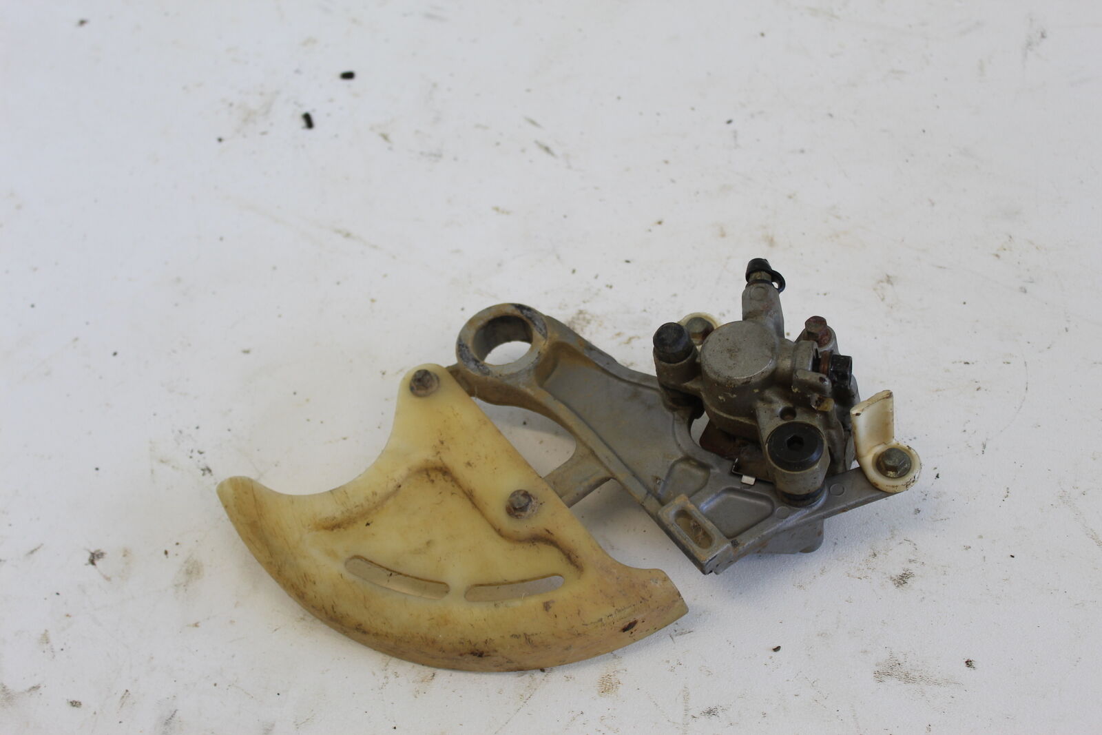 04-07 HONDA CRF450R CRF 450 R REAR BACK BRAKE CALIPER WITH HANGER BRACKET